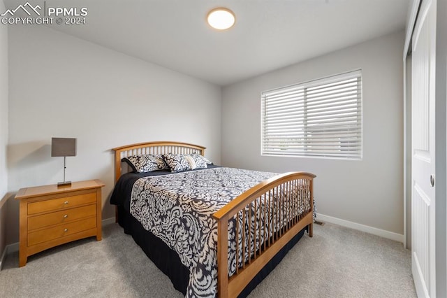 bedroom featuring light carpet