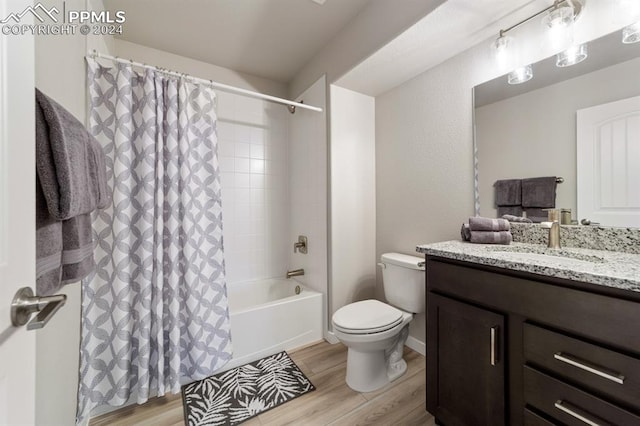 full bathroom featuring vanity, shower / bath combo with shower curtain, wood-type flooring, and toilet