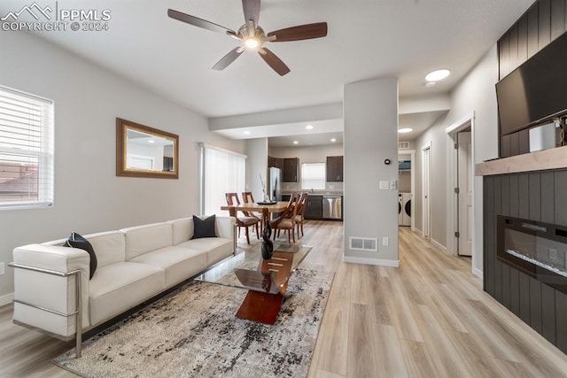 living room featuring ceiling fan and light hardwood / wood-style flooring