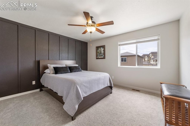 bedroom with ceiling fan and light carpet