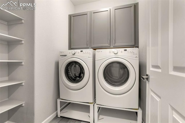 washroom with cabinets and independent washer and dryer