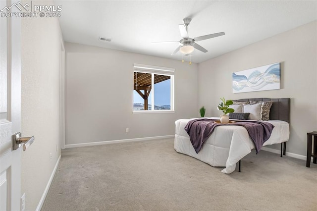 bedroom with ceiling fan and light colored carpet