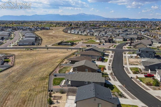 birds eye view of property featuring a mountain view