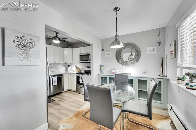 dining area with light hardwood / wood-style floors, a baseboard radiator, and ceiling fan