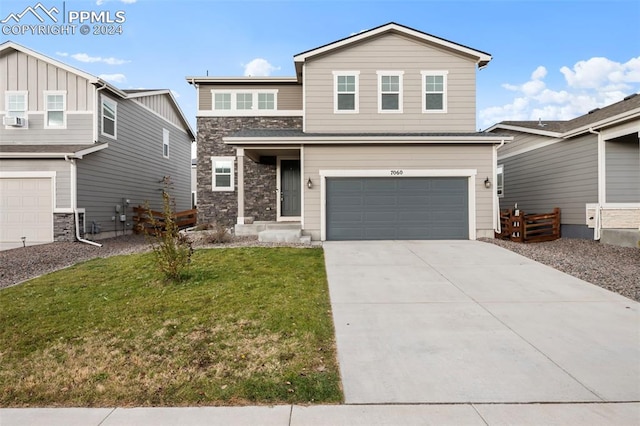 view of front of house featuring a garage and a front yard