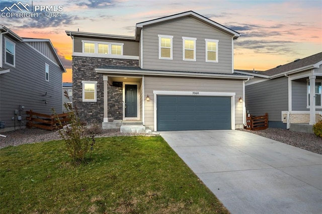 view of front of home with a lawn and a garage