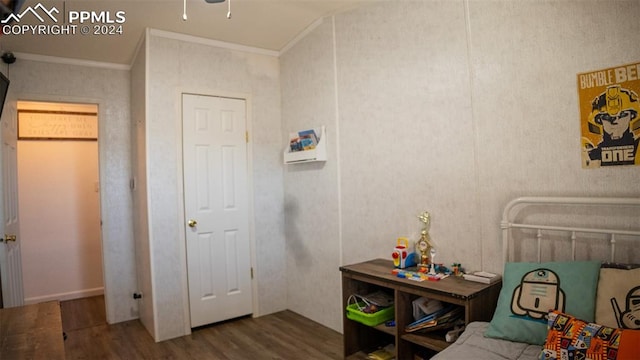 bedroom featuring ornamental molding and hardwood / wood-style floors