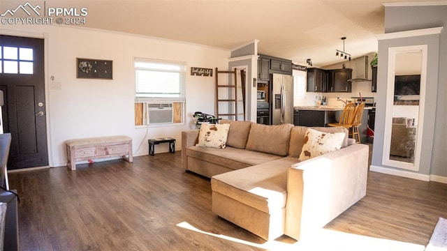 living room featuring a wealth of natural light, crown molding, cooling unit, and dark hardwood / wood-style flooring