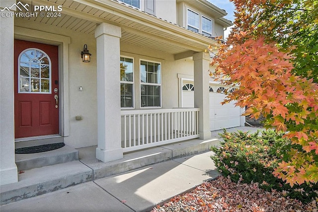 entrance to property with a garage and a porch