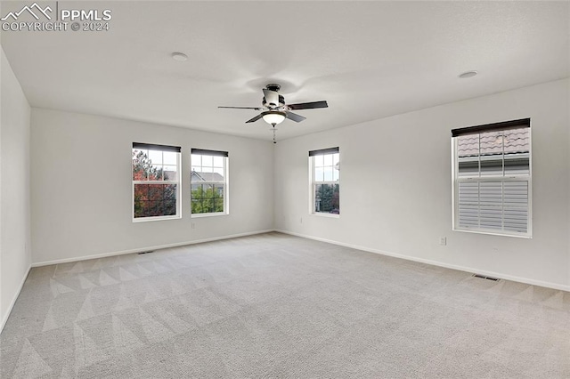 unfurnished room featuring light carpet and ceiling fan