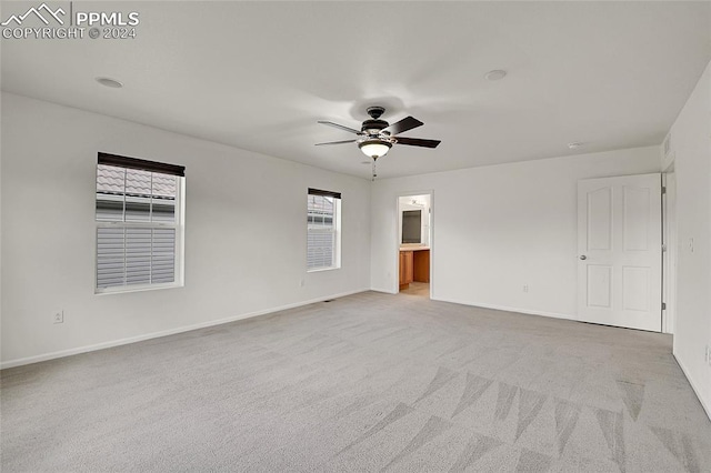 carpeted empty room with ceiling fan