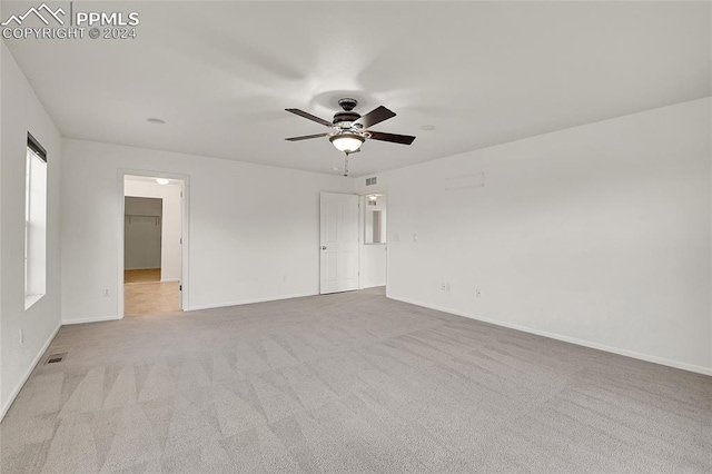 carpeted empty room featuring ceiling fan