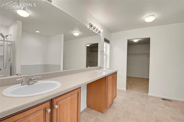 bathroom featuring vanity and a shower with shower door