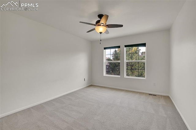 carpeted empty room with ceiling fan