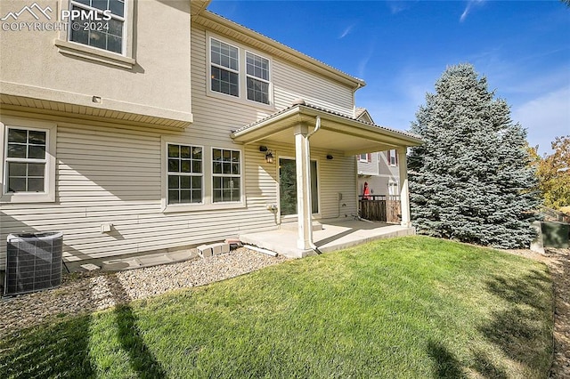 back of house featuring a patio, central AC, and a yard