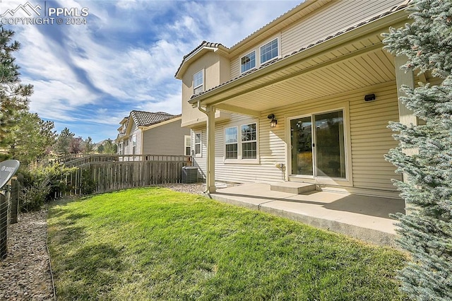 back of house featuring a yard and a patio area