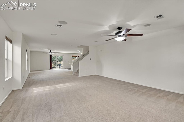 carpeted spare room with ceiling fan