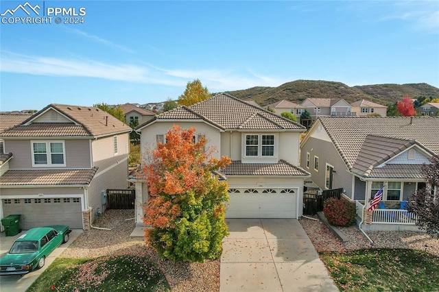 view of front of property with a mountain view and a garage