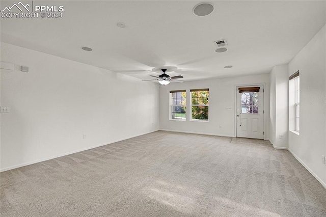 unfurnished room with ceiling fan and light colored carpet