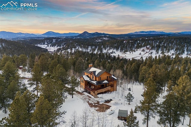 snowy aerial view with a mountain view