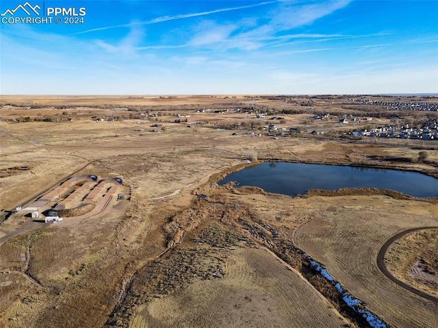 drone / aerial view featuring a water view and a rural view