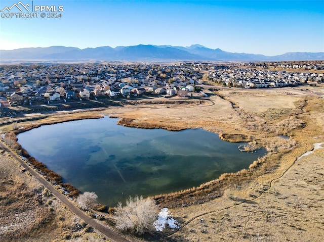 birds eye view of property with a water and mountain view