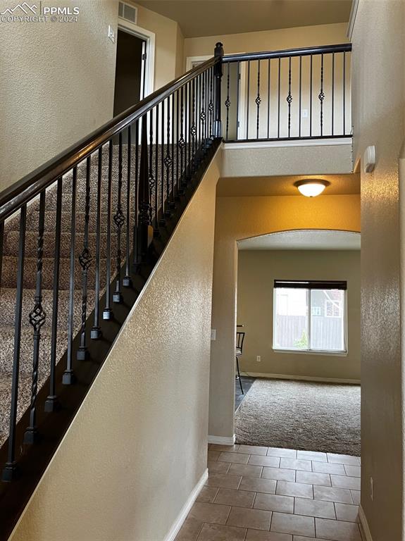 stairway featuring a high ceiling