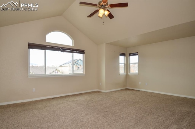 spare room with lofted ceiling, carpet flooring, and ceiling fan