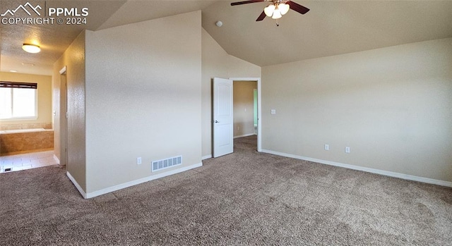 spare room featuring lofted ceiling, ceiling fan, and carpet