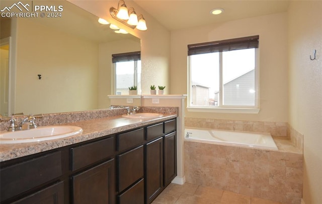 bathroom featuring vanity and a relaxing tiled tub