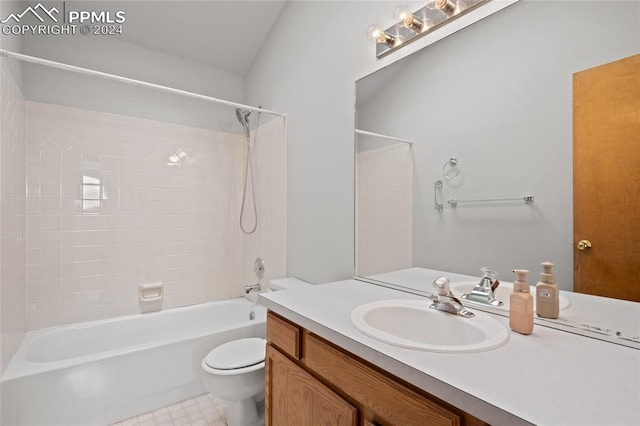 full bathroom featuring tile patterned flooring, tiled shower / bath, toilet, and vanity