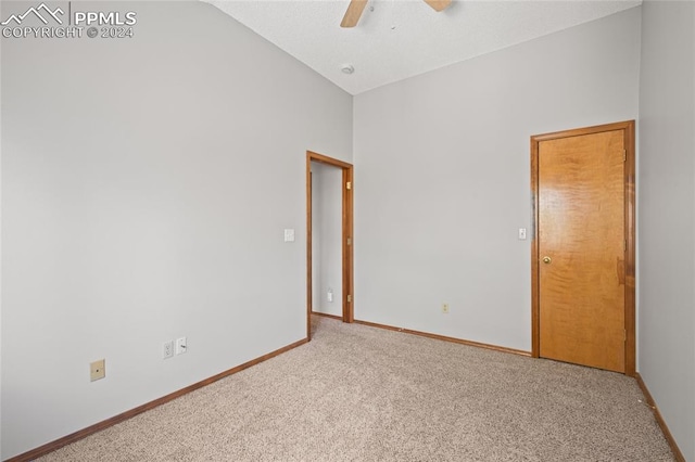 empty room featuring light colored carpet and ceiling fan