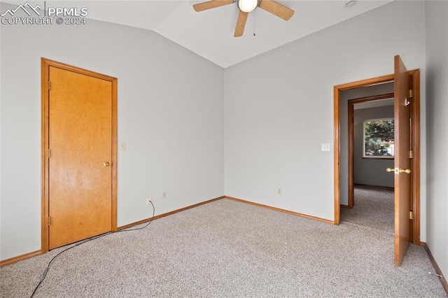 carpeted spare room with lofted ceiling and ceiling fan