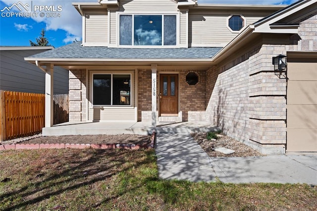 view of exterior entry featuring a porch