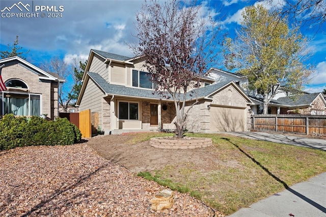 view of front of property with a front lawn and a garage