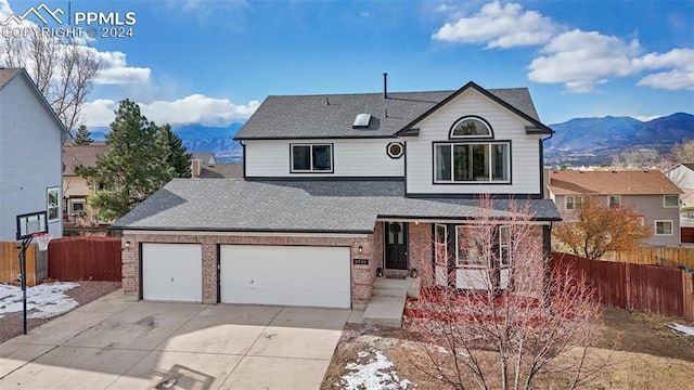 view of front property featuring a mountain view and a garage