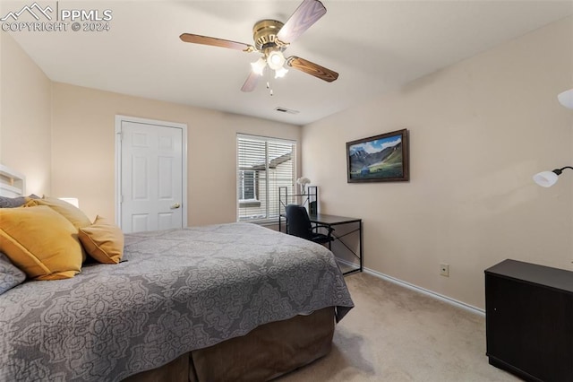 bedroom with light carpet and ceiling fan