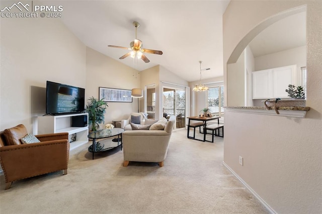 living room featuring ceiling fan with notable chandelier, light colored carpet, and high vaulted ceiling