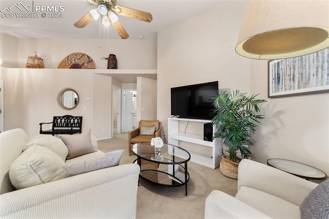 carpeted living room with ceiling fan