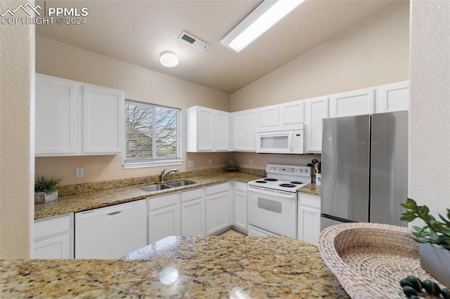 kitchen with light stone countertops, sink, white appliances, and white cabinets