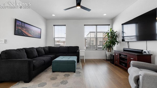 living room featuring ceiling fan and light wood-type flooring