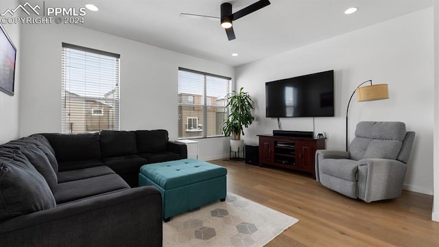 living room featuring ceiling fan and light wood-type flooring