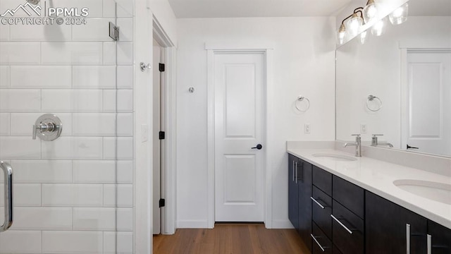 bathroom with vanity, hardwood / wood-style flooring, and walk in shower