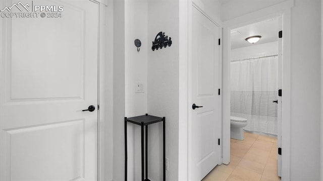 hallway featuring light tile patterned flooring