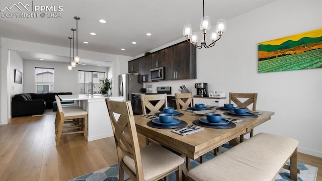 dining room with an inviting chandelier and light wood-type flooring