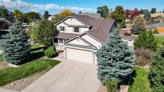 view of front of property with a front yard and a garage