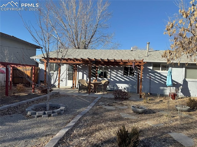 back of house with an outdoor fire pit, a patio area, and a pergola