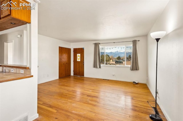 unfurnished living room with light hardwood / wood-style floors