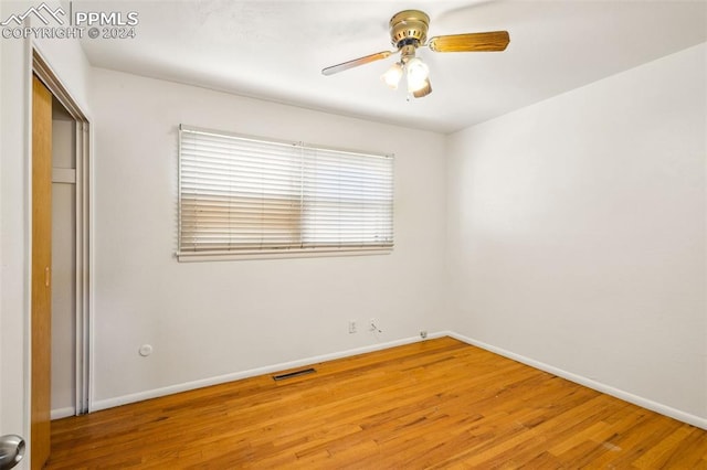 unfurnished bedroom with ceiling fan and wood-type flooring