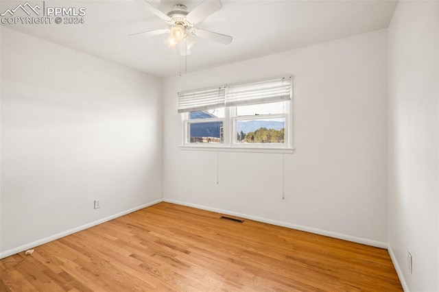 unfurnished room with ceiling fan and light wood-type flooring